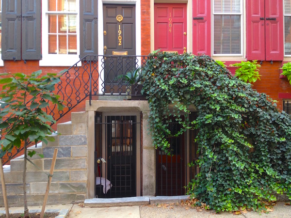 Doorways to the raised basement-level kitchens, with whimsically tall stoops arching above them