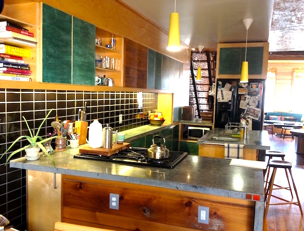 One-of-a-kind kitchen with custom built cabinets, cast concrete countertops, custom-cut slate tile backsplash