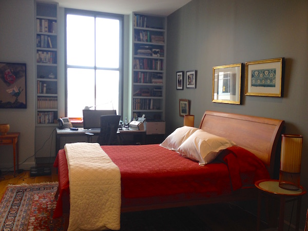 The guestroom and Richard's office features a large window flanked by built-in shelving