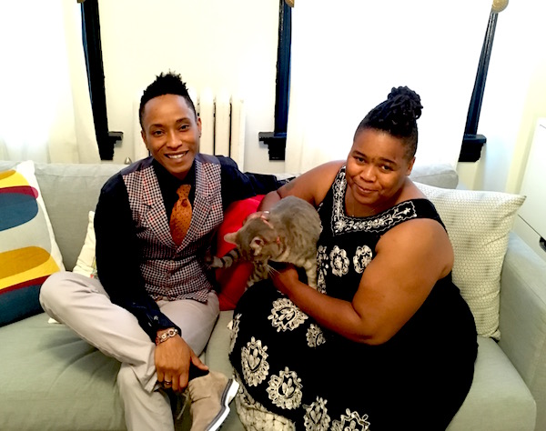 Kimberly and Latrice with Oliver, one of their two cats, in their sunny new living room