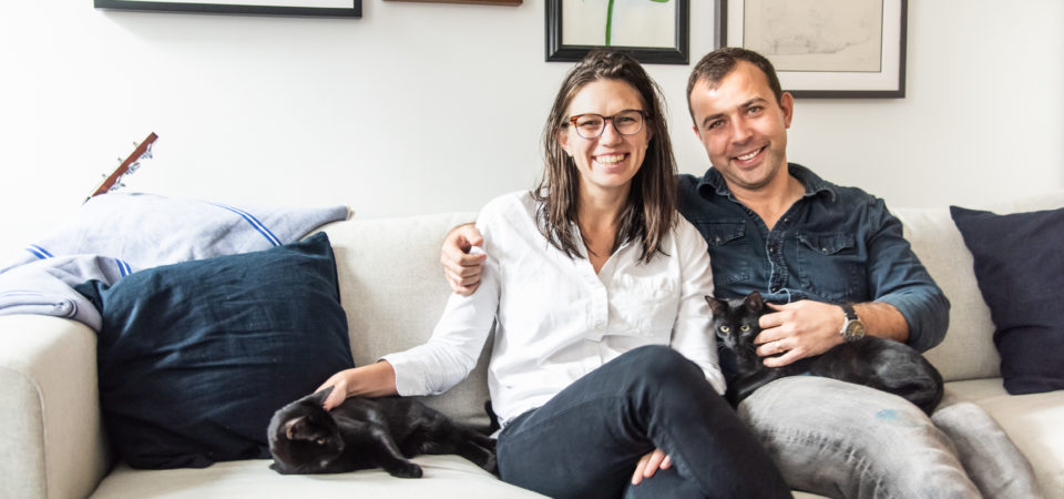 Couple on a sofa in their Philadelphia Rowhome