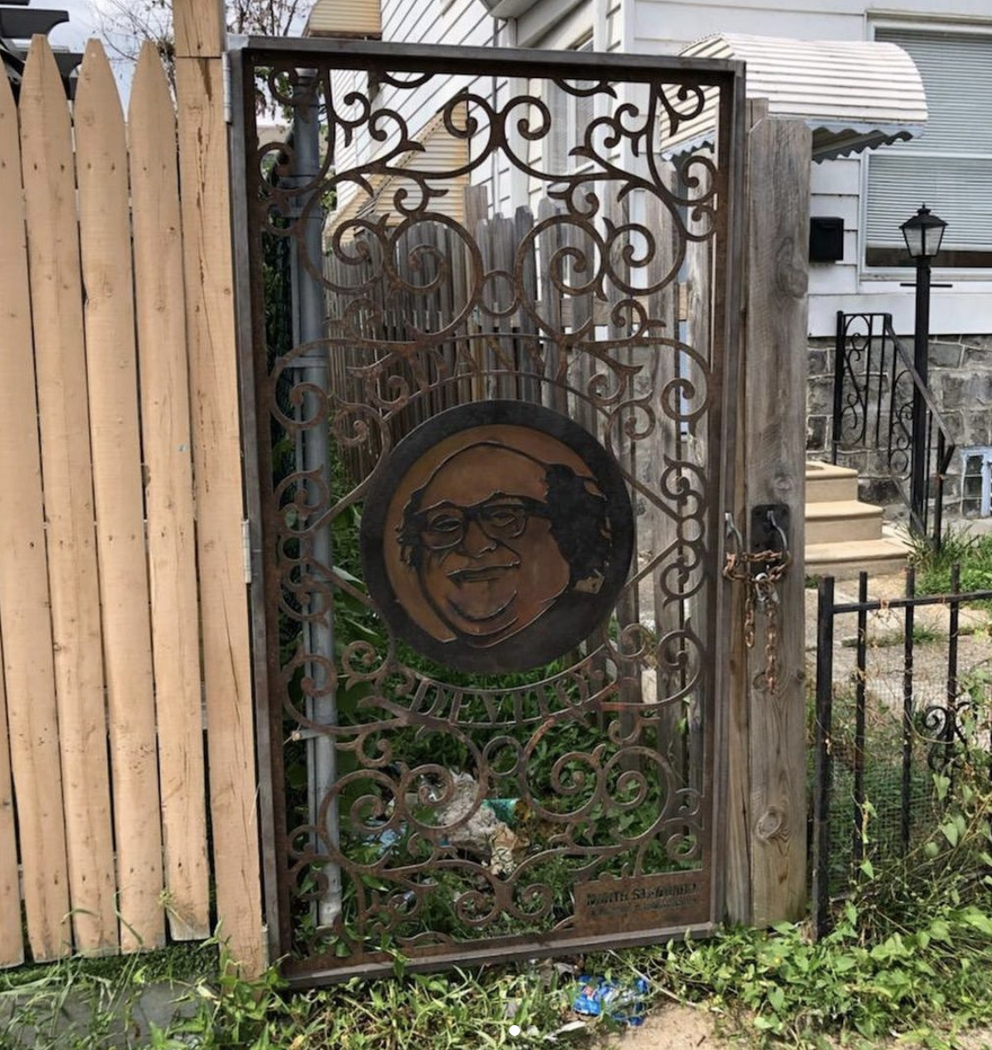 Custom alley gate in Kensington featuring Danny DeVito's face.