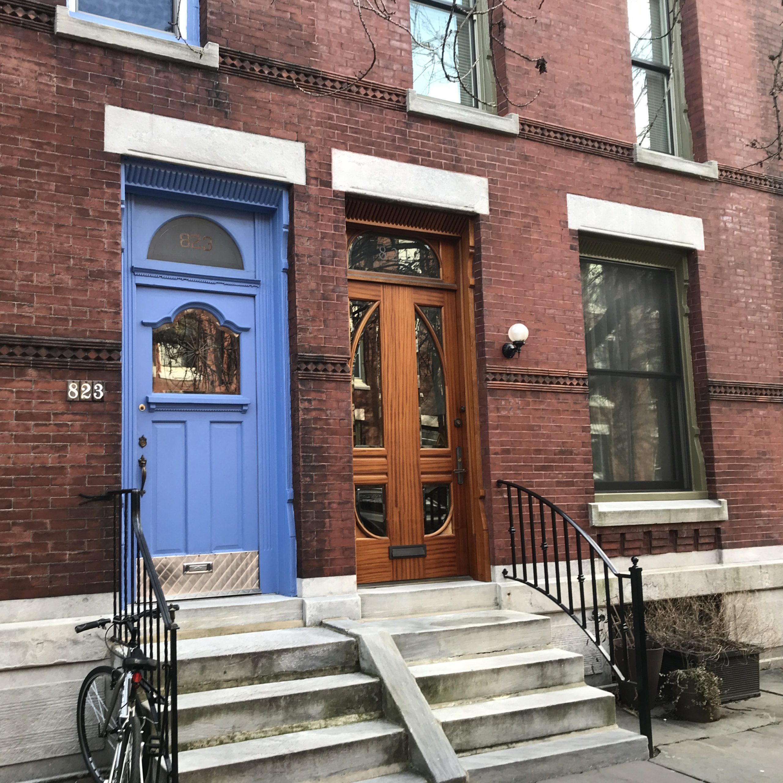 A brightly-colored "Hollywood" style front door and unique wood and glass geometric door. 