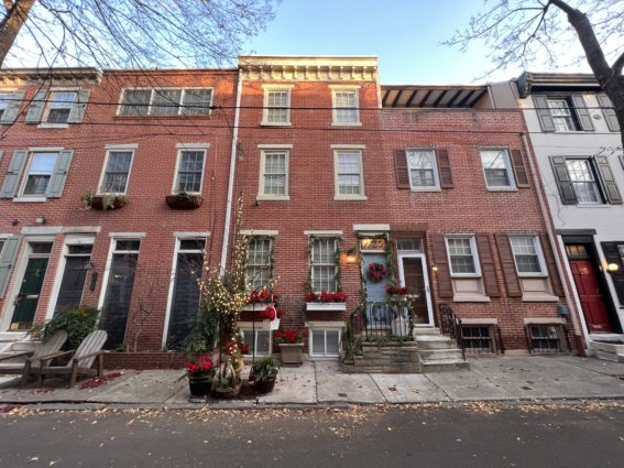 The facade of a rowhome on Addison Street is adorned with cheerful holiday decorations - Image: Cory J Popp