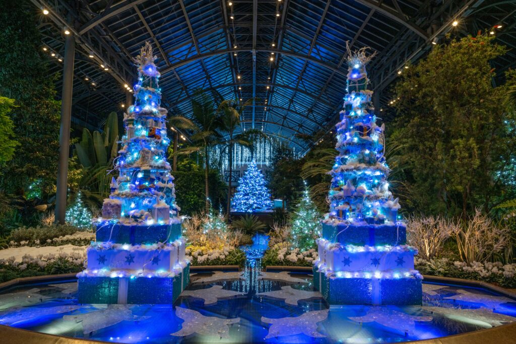 Image courtesy of Longwood Gardens. Photographer Hank Davis. The Peppermint Palace in the music room at Longwood Gardens features holiday decor like faux cakes, trees, garlands, and other decorations red and green decorations for the festive season. 
